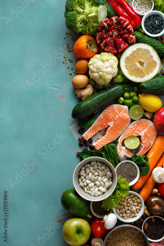 healthy food cereals seeds fish vegetables fruits stone background top view © kucherav