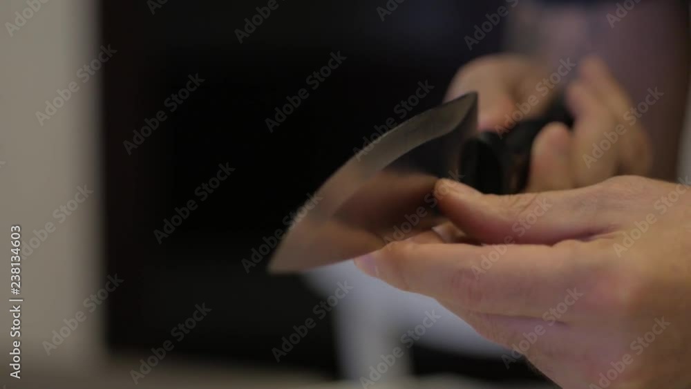 Man touches a sharp knife Man touches a sharp knife