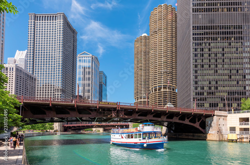 Chicago downtown and Chicago River with bridge and with tourist ship during sunny day, Chicago, Illinois. 