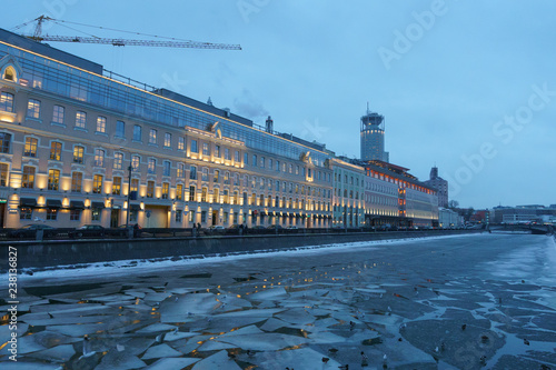 Image of Sadovnicheskaya embankment at winter sunset. A flock of ducks on the ice of Vodootvodny canal struggling for life. 