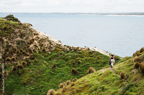 Couple explores a cliff on the coastline photo