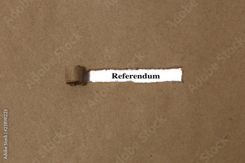 Ripped brown manilla envelope revealing the word referendum on white paper. UK Brexit deal concept