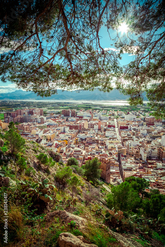 Breathtaking panoramic view from a hill on vacation area of Cullera, Valencian community, Spain. Showing the old city, mountains, river and forest.
