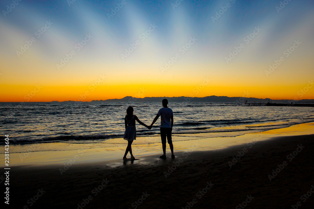 Husband and wife couple silhouette at sunset