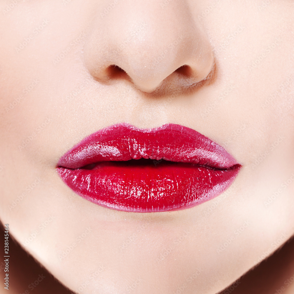 Women's lips with bright red lipstick, Rich color and glossy texture, used lip gloss. Women's lips with bright red lipstick, Rich color and glossy texture, used lip gloss.