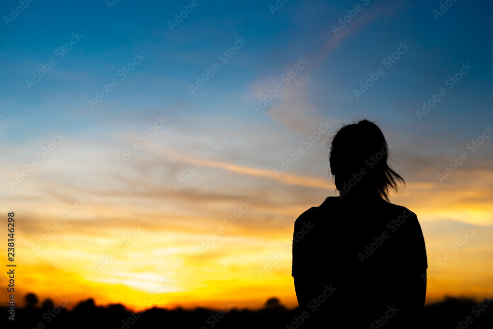 Silhouette woman standing sad in the sunset. Silhouette woman standing sad in the sunset.