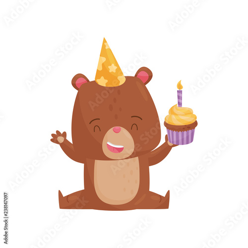 Happy humanized bear sitting on floor and holding cupcake with candle. Flat vector for Birthday postcard or poster