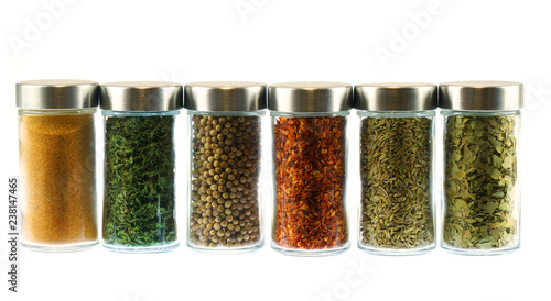 collection of spice and herbs seasoning in glasses bottles isolated on white background