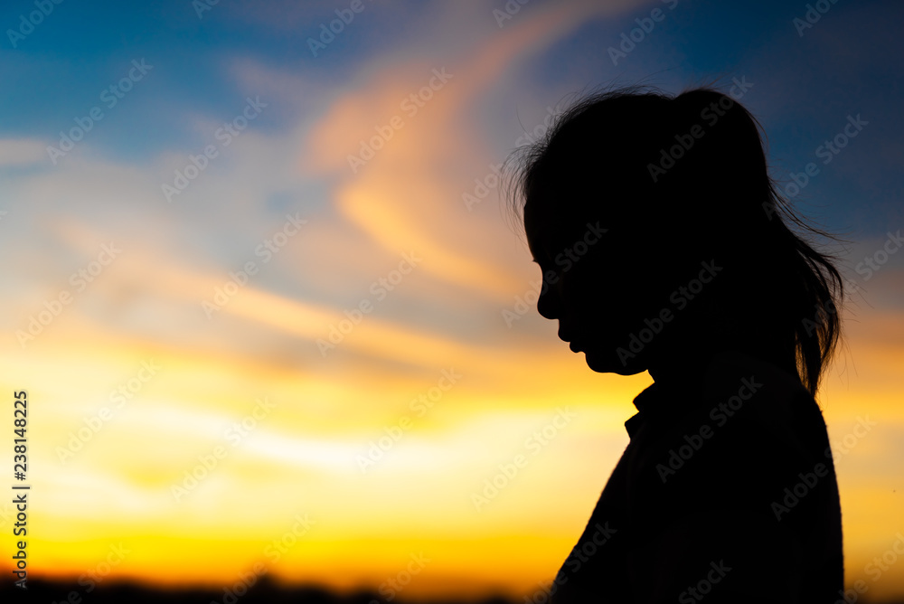 Silhouette woman standing sad in the sunset. Silhouette woman standing sad in the sunset.