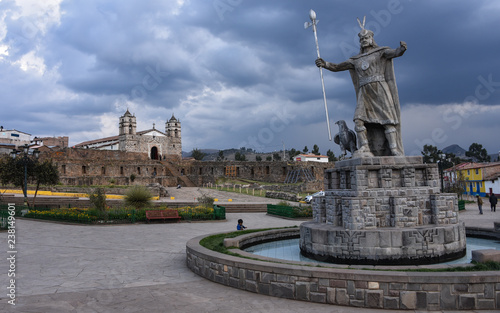 A statue of Inca Pachacutec and Catholic church in the plaza of Vilcashuaman. Ayacucho, Peru photo
