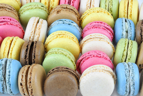 close up on colorful macarons arranged in row