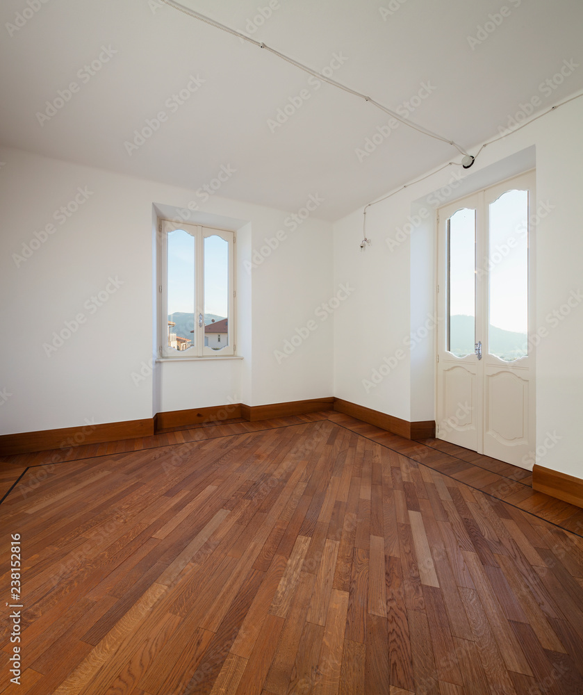 Obraz premium White empty room with two windows overlooking the Swiss hills