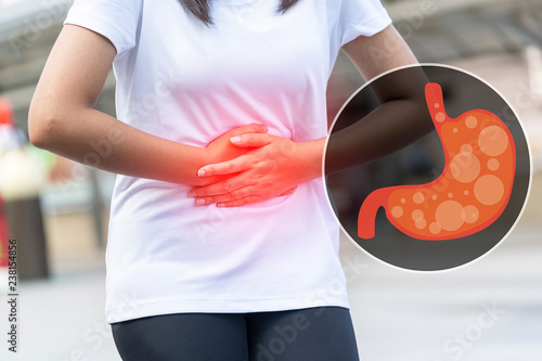 Close up of body woman Suffering from stomach painful or Acid Reflux or Heartburn,Gas,Bloating,Belching and flatulence or gastrointestinal system disease. people,medical and health insurance concept