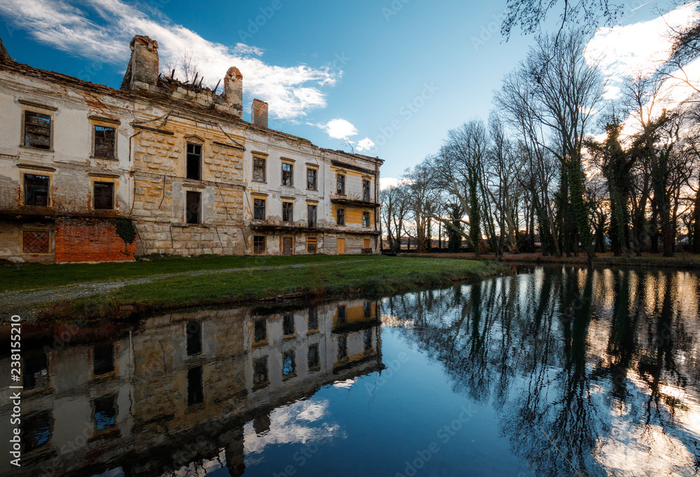 old castle pottendorf, reflection of the old building in a lake in autumn