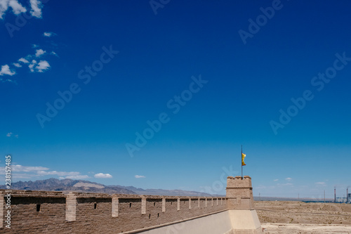 Corner tower and wall with yellow flag under blue sky  at Jiayu Pass  in Jiayuguan  China