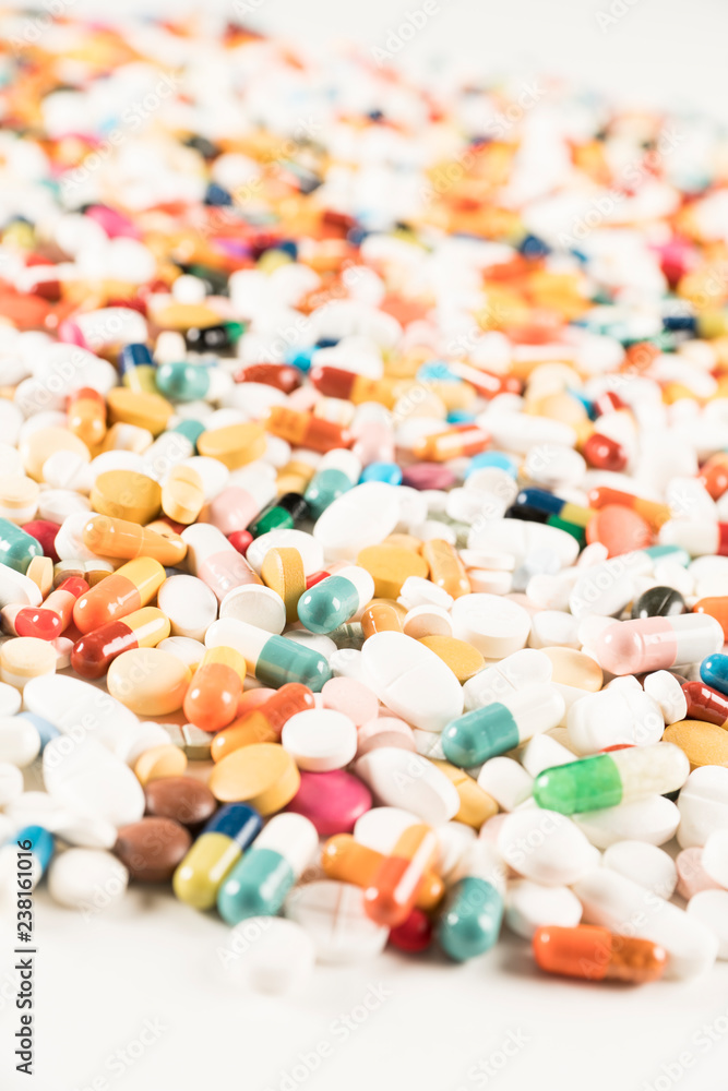 High number of pills on white background surface. High resolution image for pharmaceutical industry. High number of pills on white background surface. High resolution image for pharmaceutical industry.