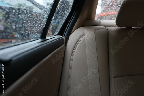 back seat inside vehicle car with rain drop on window © sutichak