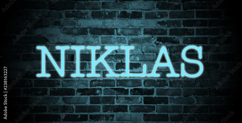 Fototapeta premium first name Niklas in blue neon on brick wall