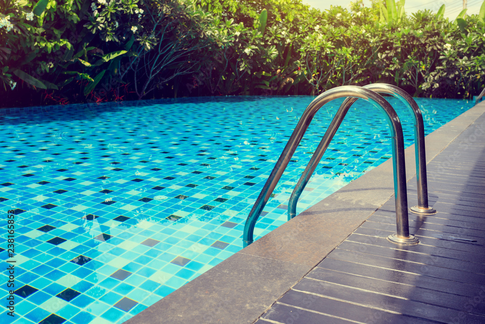 blue swimming pool around with green nature garden