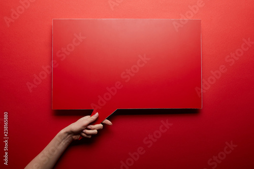 top view of empty speech bubble in red color on red background