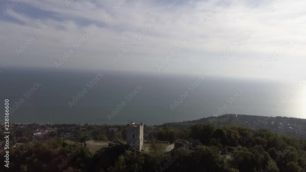 Scenery of beautiful Anacopia Fortress in Abkhazia and amazing Black Sea with long shore coast connecting with valley and green hills on summer sunny day with amazing blue sky. Scenery of beautiful Anacopia Fortress in Abkhazia and amazing Black Sea with long shore coast connecting with valley and green hills on summer sunny day with amazing blue sky.