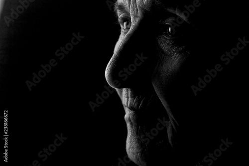 Portrait of an old grandmother's face in profile in the dark