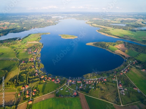 Aerial view of beautiful Kal village (former Kehlen or Kielno, East Prussia) located on Swiecajty Lake shore, Mazury, Poland photo