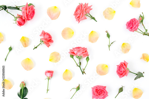 Floral pattern made of roses flowers and petals on white background. Flat lay, top view.