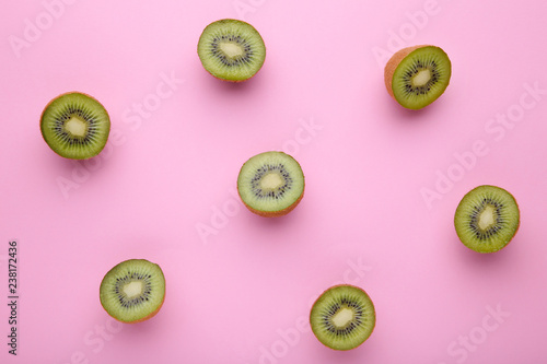 Half of kiwi fruits on pink wooden background