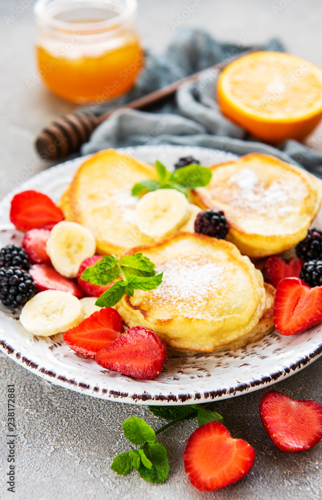 Delicious pancakes with berries on a concrete backrgound Delicious pancakes with berries on a concrete backrgound