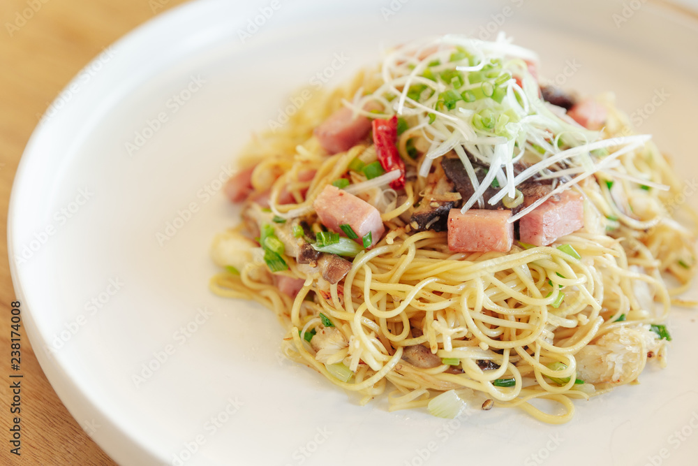 Close up Stir fried Chinese noodle with ham and crab meat on wooden table background. Close up Stir fried Chinese noodle with ham and crab meat on wooden table background.