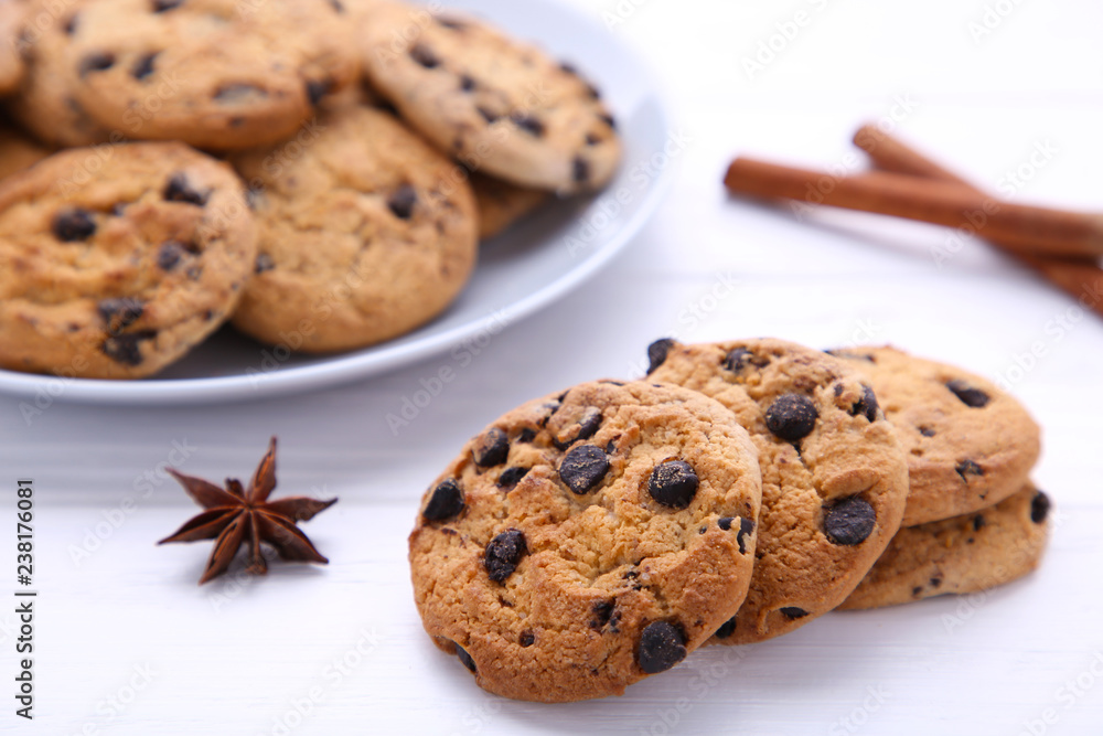 Chocolate cookies on plate on white wooden background Chocolate cookies on plate on white wooden background