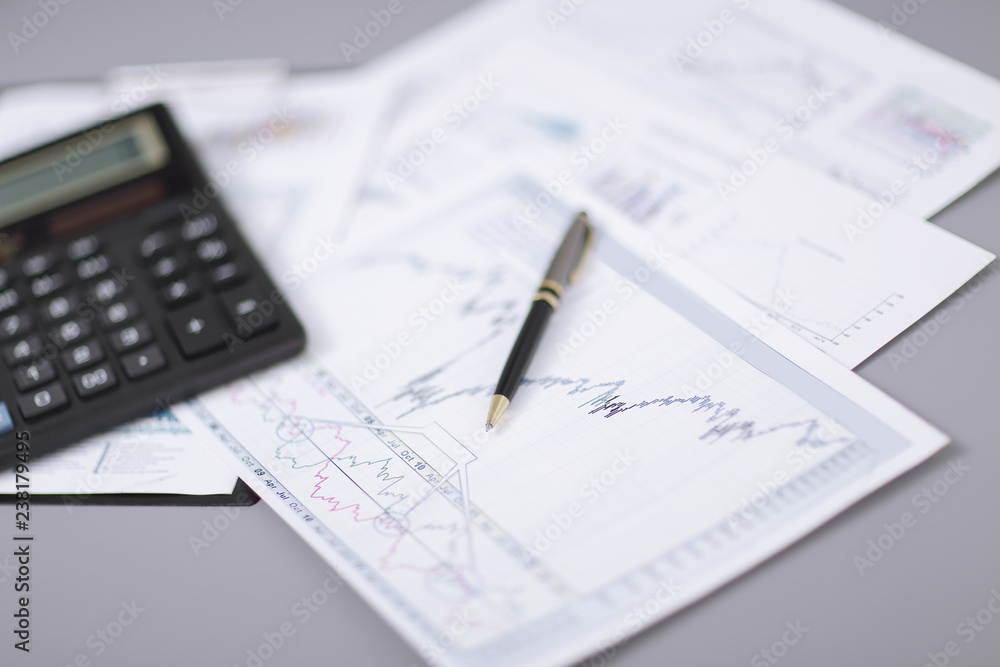 close up.pen, financial chart and calculator on the desktop close up.pen, financial chart and calculator on the desktop