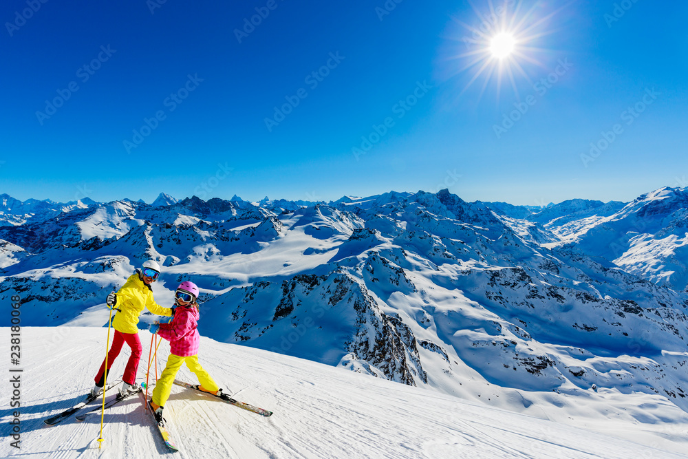 Happy family enjoying winter vacations in mountains . Ski, Sun, Snow and fun.