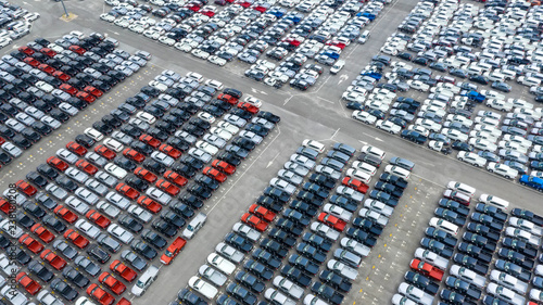 Cars export terminal in export and import business and logistics. Shipping cargo to harbor. Water transport International. Aerial view and top view.