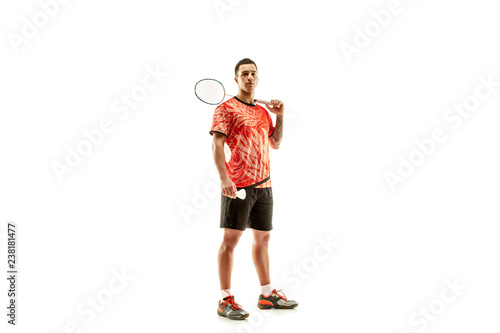 Young man badminton player standing over white studio background. Fit male athlete