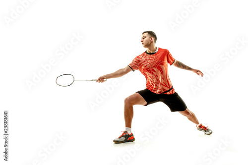 Young man playing badminton over white studio background. Fit male athlete isolated on white. badminton player in action, motion, movement. attack and defense concept