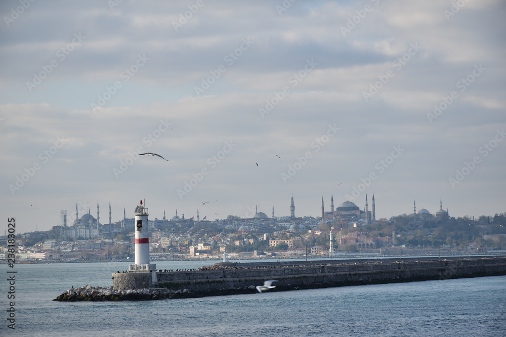 silhouette of Istanbul behind the lighthouse