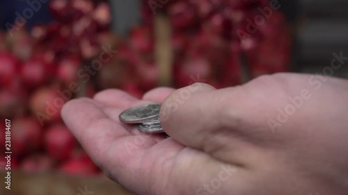 man's hand with coins grocery market