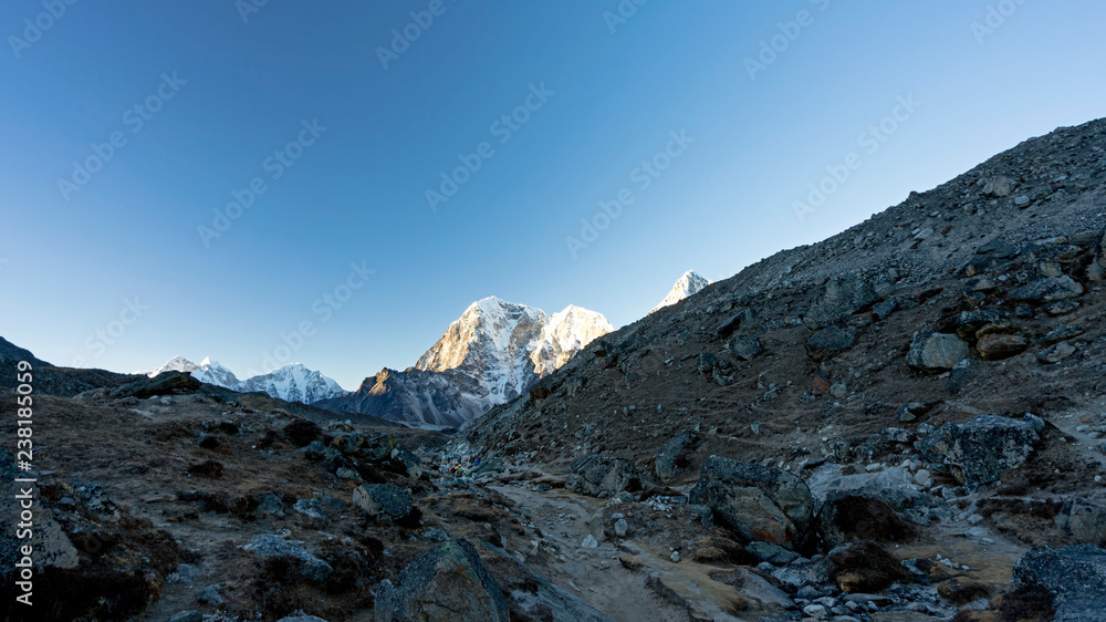 Pyramid is one of the smaller peaks in the Everest region, overlooking Italian research station. Early morning hikers are coming down the path on their way to Khumbu Glacier. Pyramid is one of the smaller peaks in the Everest region, overlooking Italian research station. Early morning hikers are coming down the path on their way to Khumbu Glacier.