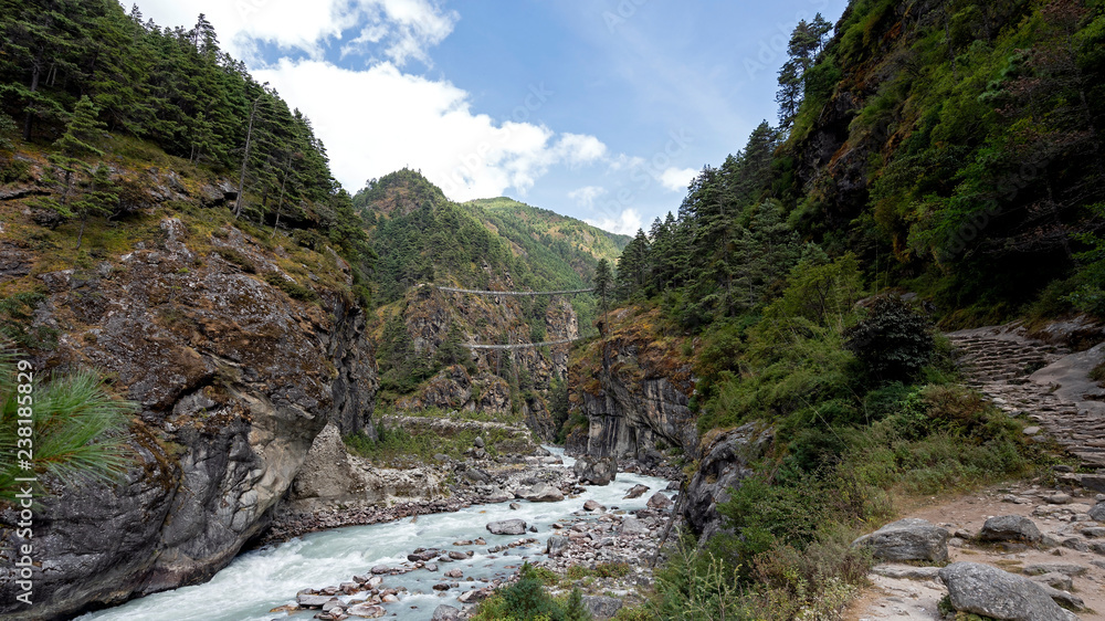 Suspension bridges over a river along the path towards Namche town of Khumbu region.