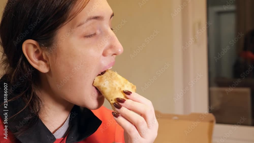 Beautiful woman enjoy eating pizza at home, close up Beautiful woman enjoy eating pizza at home, close up