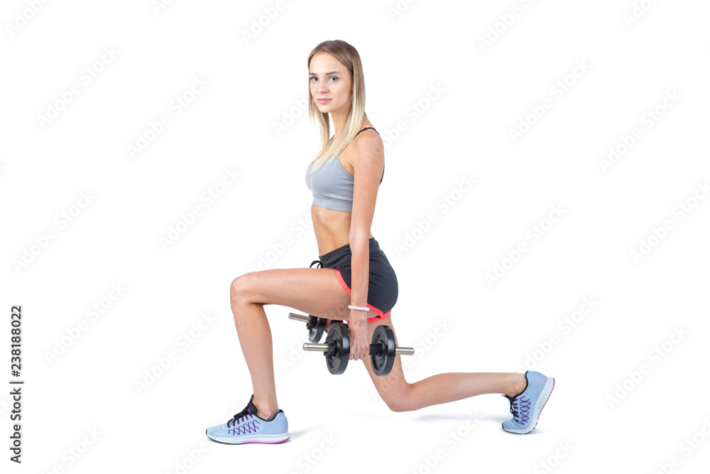 Beautiful young slim girl with dumbbells on a white background. Novice athlete