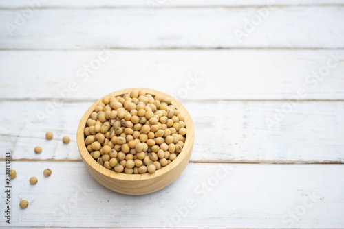 Soybean  in a wooden bowl on white wood background