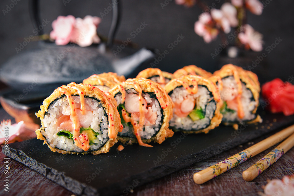 Hot fried Sushi Roll with salmon, shrimp, onion, avocado and cheese. Sushi menu. Japanese food. Hot fried Sushi Roll with salmon, shrimp, onion, avocado and cheese. Sushi menu. Japanese food.