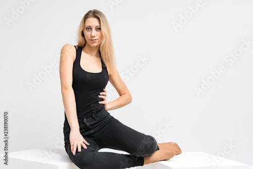 Concept portrait of a beautiful blonde girl smiling on a white background advertises product. She is right in front of the camera and shows different emotions.