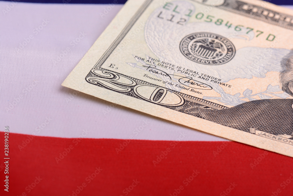 twenty dollar bill in front of the American flag twenty dollar bill in front of the American flag