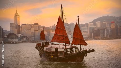 Beautiful view in the morning with Chinese Junk ship operating in Victoria Harbour, Hong Kong.
