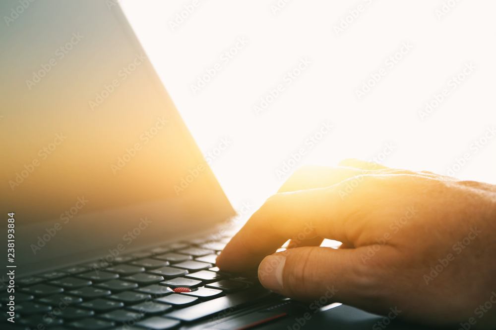 Foto Image of man's hand typing over laptop keyboard at office, workplace or home