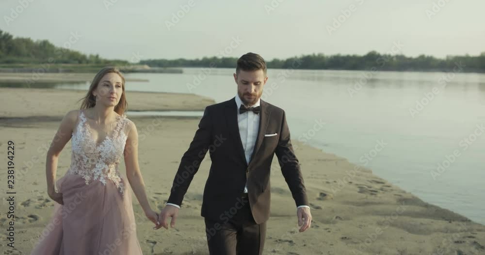 Young husband and wife are walking on the beach. Young husband and wife are walking on the beach.